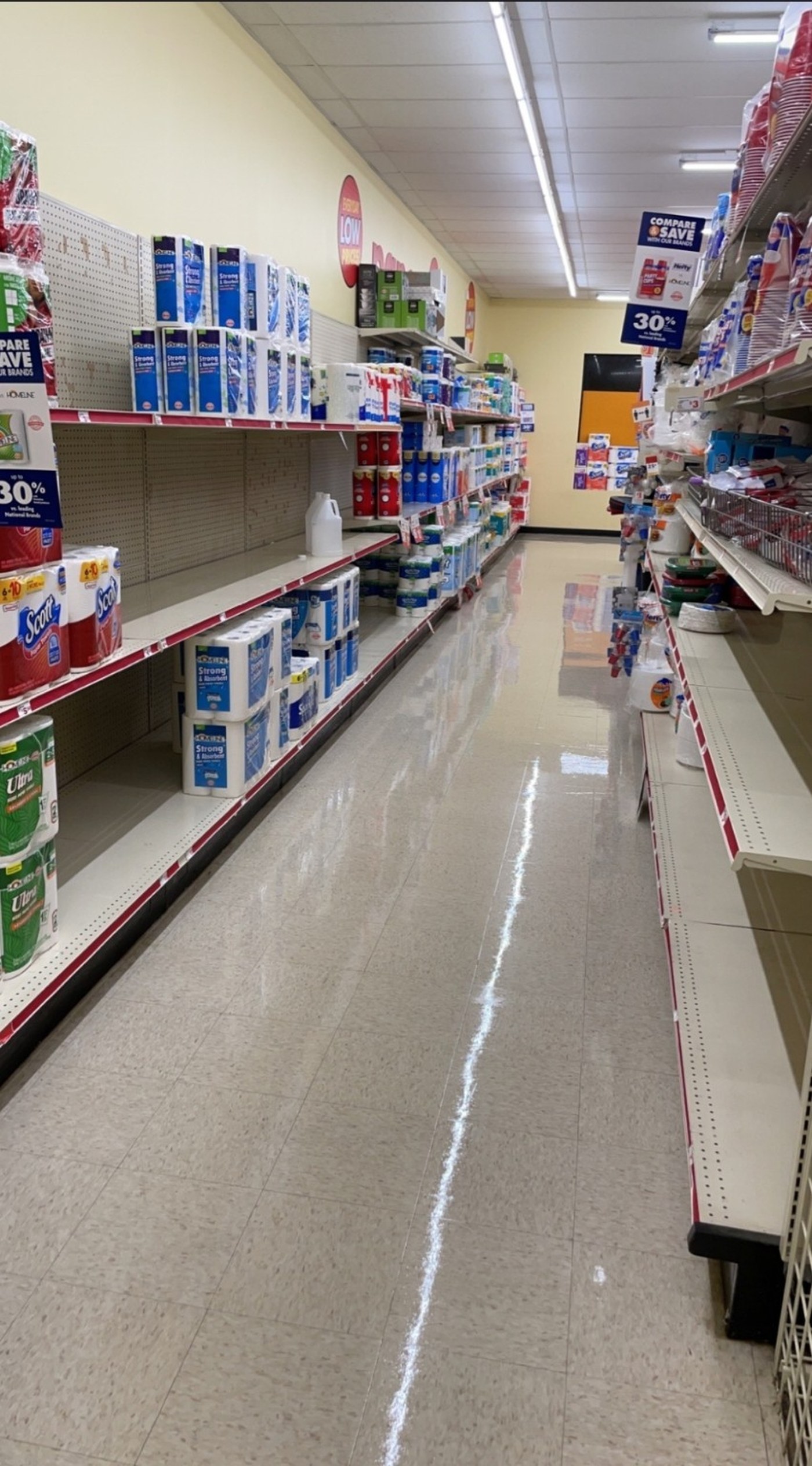 Family Dollar retail aisle during recurring maintenance program — post-scrub condition