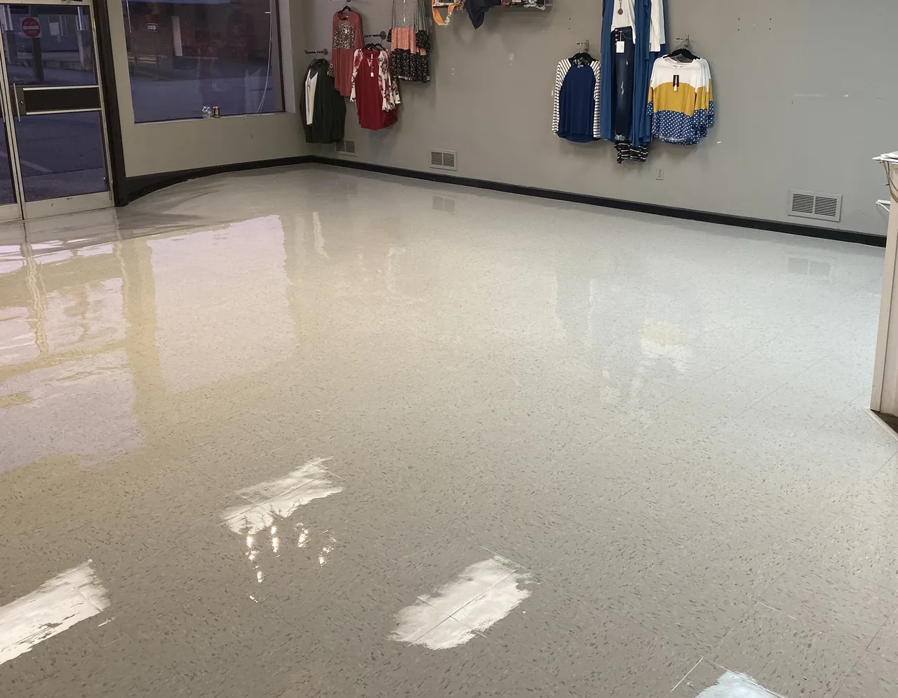 Completed white VCT floor in a customer-facing boutique commercial space in Ashland, Kentucky