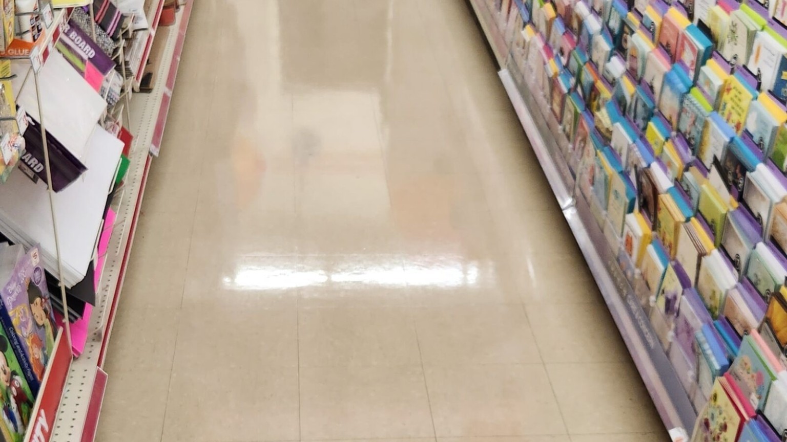 Polished VCT in a retail greeting card aisle under recurring service